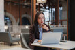 © crizzystudio - Asian businesswoman concentrating while working on laptop