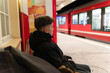 © Juanmarcos - Young man waiting for arriving train at station platform