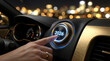 © PhotoGranary - Hand pressing a glowing 2026 start button on a luxury car dashboard. Night city driving concept representing the beginning of a New Year journey with blurred bokeh lights.