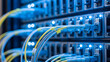 © Iuliia - Close up of fiber optic cables and server rack connections in a data center. High speed network communication and internet technology concept.