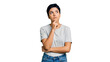 © Mounya - Thoughtful woman pondering a decision, contemplating options with a hand on her chin, reflecting