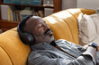 © ReeldealHD images - Man Resting with Headphones in Cozy Living Space