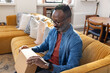 © ReeldealHD images - Smiling man about to open online order at home