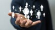 © David - Digital network of white people icons floating above a businessman's hand, representing social connection, community, and human resources management in a futuristic interface