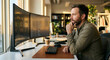 © MYDAYcontent - A trader focuses on dual monitors while working from home in a bright setting