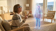 © MYDAYcontent - A boy wearing VR glasses interacts and laughs with a hologram at home