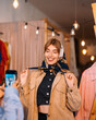 © Big Shot Theory - A Fashionable Young Woman is Posing with a Stylish Scarf inside a Boutique