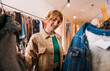 © Big Shot Theory - A woman is shopping for stylish and fashionable clothes in a trendy boutique store