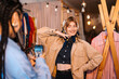 © Big Shot Theory - Stylish Young Woman Posing in Trendy Clothing Store with Friend Capturing Moment