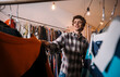© Big Shot Theory - An Enthusiastic Young Man Happily Shopping in a Vintage Clothing Store Today