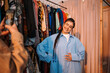© Big Shot Theory - A Fashionable and Stylish Young Woman Posing Gracefully in a Vintage Clothing Store