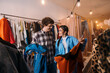 © Big Shot Theory - Fashion Trend Exploration: Friends Trying On Stylish Outfits in a Boutique