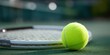 © Iryna - Bright tennis ball near racket on outdoor court on sunny day