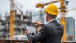 © Jayk - Construction engineer reviewing a project on a tablet at a building site
