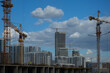 © Tatiana - Construction cranes and new buildings, construction work of modern skyscrapers on a sunny day.