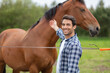 © auremar - happy man next to horse at fence