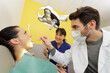 © auremar - dentist examining his beautiful patient in dentists office
