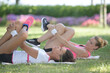 © auremar - women doing leg exercises layed on the grass