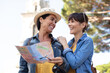 © auremar - two female tourist looking at the map of parisian metro