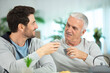 © auremar - adult son helping senior father at home