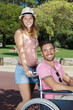 © auremar - young couple in wheelchair strolling in the park