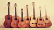 © PureMe - concerto. Six acoustic guitars arranged artistically on a neutral background, showcasing warm wood tones. tutorial guides, club newsletters, designed for tourism and weekend activity guides.