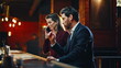 © stockbusters - Elegant couple arriving restaurant together closeup. Lady talking mobile device