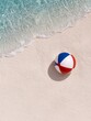 © yuri - A colorful beach ball rests on white sand near the edge of the ocean, with clear water and small waves. The image is taken on a sunny day.
