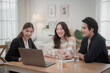 © surachetkhamsuk - Asian financial consultant explaining new project investment to young couple in office. Real estate agent discussing mortgage options with family. Mortgage loan consultation.