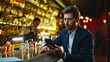 © stockbusters - Depressed man looking cellphone screen at night pub. Sad guy feeling stress