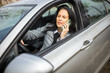 © Mediteraneo - Woman talking on phone while driving