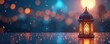 © miss irine - Intricate Islamic lantern glows at night. Festive lights blur, creating magical atmosphere. Ramadan or Eid celebration. Warm light reflects on wet surface. Night sky bokeh background.