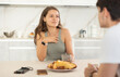 © JackF - Young guy and young girl drink tea and talk while sitting in kitchen at home