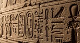 Close up of ancient egyptian hieroglyphs carved into a stone wall with detail view