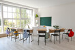 © Pixel-Shot - Interior of empty classroom with school desks and clean chalkboard