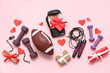 © Pixel-Shot - Composition with different sports equipment, gifts and paper hearts on pink background. Valentine's Day celebration
