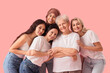 © Pixel-Shot - Group of beautiful women hugging on pink background. Women's History Month