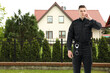 © New Africa - Security guard in uniform near house outdoors. Private property protection