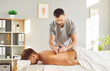 © Studio Romantic - Man professional masseur physiotherapist in uniform making medical massage of back for relaxed male patient lying on the couch in clinic. Rehabilitation and osteopathic medicine concept.