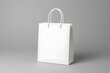 © melano - Stylish white shopping bag mockup for branding or retail design presentation on gray background, conveying elegance and modernity for commercial use