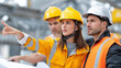 © Julia - Multiple workers discussing plan, pointing toward structure, helmets shining, collaborative tension, blurred background with copy space