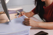 © Phimwilai - Woman's hands managing pile of papers, checking documents