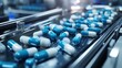 © hsantima - Blue and white capsules on a production line.