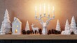 © Zabi - White christmas decorations on a wooden shelf with deer and trees and a house and candles burning
