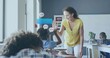 © vectorfusionart - Leaning teacher in yellow blouse white pants high-fiving boy in class right side, desk, copy space