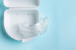 © Alexandra - Anti snoring mouth guard made of reusable silicone shown on a white table or blue backdrop. The device is displayed from a side view or top view, clean and minimal, medical product style.