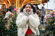 © AnastasiiaAkh - indian woman standing by christmas carousel at senate square helsinki