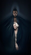 © master1305 - Stylized portrait of two dancers wrapped in dark fabric on deep shadow background. Concept of conceptual storytelling, mysterious visuals, artistic character imagery.