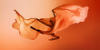 © master1305 - Ballet dancer floating under large orange fabric wave on warm background. Concept of campaign visuals, airy dance moments, editorial movement photography.
