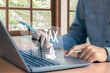© bancha - Tax return calculation concept financial research government tax businessman using laptop filling out income tax form online for payment